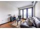 Cozy living room showcasing a leather sofa, a TV, and balcony access with great natural light at 5300 Peachtree Rd # 3206, Atlanta, GA 30341