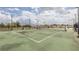 Outdoor community tennis court with green surface, net, and benches at 5300 Peachtree Rd # 3206, Atlanta, GA 30341