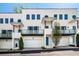 Modern townhome featuring white brick, private balconies, garage, and stylish architectural details at 1337 Grey Fox Ne Ct, Atlanta, GA 30306