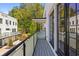 Relax on the balcony with glass railings and enjoy the serene view of the lush surroundings at 1337 Grey Fox Ne Ct, Atlanta, GA 30306
