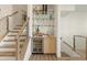 Convenient bar area with glass shelving, wine cooler, and stylish finishes near the staircase at 1337 Grey Fox Ne Ct, Atlanta, GA 30306