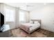 Bright bedroom features a ceiling fan, neutral walls, wood floors, and windows with natural light at 1337 Grey Fox Ne Ct, Atlanta, GA 30306