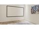 Bonus room with white walls, wood floors, and a large projection screen for entertainment at 1337 Grey Fox Ne Ct, Atlanta, GA 30306