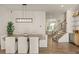 Modern dining area with stylish light fixture, bar area, and staircase with glass railing at 1337 Grey Fox Ne Ct, Atlanta, GA 30306