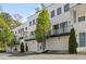 Row of modern townhomes with white brick, balconies, and garages, showcasing contemporary architectural design at 1337 Grey Fox Ne Ct, Atlanta, GA 30306