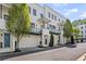 Modern townhome with white brick facade, balconies, and attached garages, offering stylish urban living at 1337 Grey Fox Ne Ct, Atlanta, GA 30306