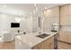 Modern kitchen with center island seating, unique lighting fixtures and open to an adjacent living area at 1337 Grey Fox Ne Ct, Atlanta, GA 30306