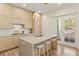Modern kitchen with a center island, stool seating, and pendant lighting next to a patio door at 1337 Grey Fox Ne Ct, Atlanta, GA 30306