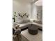 Bright living room with L-shaped couch, patterned rug, modern art, and decorative mirrors at 1337 Grey Fox Ne Ct, Atlanta, GA 30306