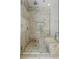 Walk-in shower features stylish stone tile and glass door at 1337 Grey Fox Ne Ct, Atlanta, GA 30306
