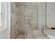 Contemporary shower with stone tile, glass door, and built-in bench at 1337 Grey Fox Ne Ct, Atlanta, GA 30306