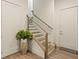 Modern stairway with wood handrails, light wood treads, and decorative plant at 1337 Grey Fox Ne Ct, Atlanta, GA 30306