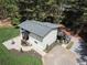 A high-angle view reveals the home's exterior, patio, driveway and surrounding woods at 418 Robinson Rd, Peachtree City, GA 30269