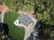 Aerial view of a modern home showcasing landscaping, patio, and driveway at 418 Robinson Rd, Peachtree City, GA 30269