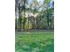View of a green backyard with trees, offering a serene outdoor space at 418 Robinson Rd, Peachtree City, GA 30269