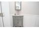 Charming bathroom featuring a corner sink with gray cabinets and modern fixtures at 418 Robinson Rd, Peachtree City, GA 30269