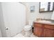 Functional bathroom features tile floors, toilet, sink with vanity, and a shower with a white curtain at 418 Robinson Rd, Peachtree City, GA 30269