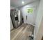 Bright entryway features wood flooring, stainless steel fridge, and white door allowing ample natural light at 418 Robinson Rd, Peachtree City, GA 30269