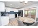 Modern kitchen featuring white cabinets, black appliances, and a breakfast nook with seating at 418 Robinson Rd, Peachtree City, GA 30269