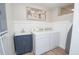 Bright laundry room features a sink, washer, dryer, and neutral decor for a clean aesthetic at 418 Robinson Rd, Peachtree City, GA 30269