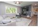 Cozy living room featuring a large window, modern decor, and wood-look flooring at 418 Robinson Rd, Peachtree City, GA 30269