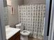 Cozy bathroom with a patterned shower curtain and neutral wall color at 6490 Emerald Pointe Circle, Atlanta, GA 30349