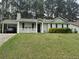 Charming one-story home with a quaint front porch and a convenient carport for covered parking at 6490 Emerald Pointe Circle, Atlanta, GA 30349
