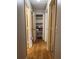 Central hallway with wood floors and access to a storage closet at 6490 Emerald Pointe Circle, Atlanta, GA 30349