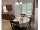 Eat-in kitchen featuring wood cabinets, matching table, and natural light at 6490 Emerald Pointe Circle, Atlanta, GA 30349
