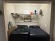 This laundry room features a pair of front-load laundry machines and a wire rack at 6490 Emerald Pointe Circle, Atlanta, GA 30349