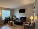 Inviting living room with hardwood floors, natural light, and comfortable seating arrangement at 6490 Emerald Pointe Circle, Atlanta, GA 30349