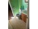 Standard bathroom featuring a toilet, vanity with sink, and neutral tile flooring at 6675 Hidden Brook Trl, Atlanta, GA 30349