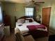 Cozy bedroom with wooden furniture and a ceiling fan at 6675 Hidden Brook Trl, Atlanta, GA 30349