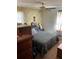 Bedroom with ceiling fan and bed with plaid spread at 6675 Hidden Brook Trl, Atlanta, GA 30349