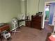 Bedroom with green walls, brown carpet, and doorway leading to bathroom with a window at 6675 Hidden Brook Trl, Atlanta, GA 30349