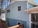 Exterior side of a home with blue siding and a wooden deck at 6675 Hidden Brook Trl, Atlanta, GA 30349