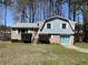 Charming split-level home with light blue siding and well-maintained front yard at 6675 Hidden Brook Trl, Atlanta, GA 30349