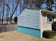 Home's exterior features light blue siding, brick accents, and a manicured green bush, enhancing its curb appeal at 6675 Hidden Brook Trl, Atlanta, GA 30349