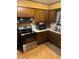 Functional kitchen featuring stainless steel appliances and wood cabinets at 6675 Hidden Brook Trl, Atlanta, GA 30349