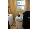 Laundry area in basement with washer and dryer hookups and exterior window view at 6675 Hidden Brook Trl, Atlanta, GA 30349