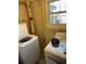 Laundry area in basement with washer and dryer hookups and exterior window view at 6675 Hidden Brook Trl, Atlanta, GA 30349