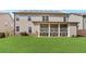 Exterior shot of a backyard with a screened porch and level green lawn at 3610 Central Park Dr, Loganville, GA 30052