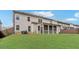 Exterior shot of a backyard with a screened porch and level green lawn at 3610 Central Park Dr, Loganville, GA 30052