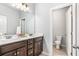 Bathroom with dark cabinets, double sinks, granite countertop, and tile floors at 3610 Central Park Dr, Loganville, GA 30052