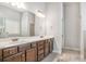Bathroom with granite countertop, double sinks, dark cabinets, and neutral paint at 3610 Central Park Dr, Loganville, GA 30052