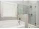 Bathroom features a garden tub and a glass enclosed shower with grey tile surround at 3610 Central Park Dr, Loganville, GA 30052