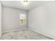 Neutral bedroom with carpet, a single window, and neutral colored walls at 3610 Central Park Dr, Loganville, GA 30052