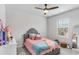 Lovely bedroom with plush carpet, a ceiling fan, neutral walls, and a window at 3610 Central Park Dr, Loganville, GA 30052