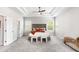 Large primary bedroom with neutral walls, two windows, and ensuite bathroom access at 3610 Central Park Dr, Loganville, GA 30052