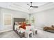 Spacious bedroom features tray ceilings, a ceiling fan, neutral walls, and plush carpet at 3610 Central Park Dr, Loganville, GA 30052